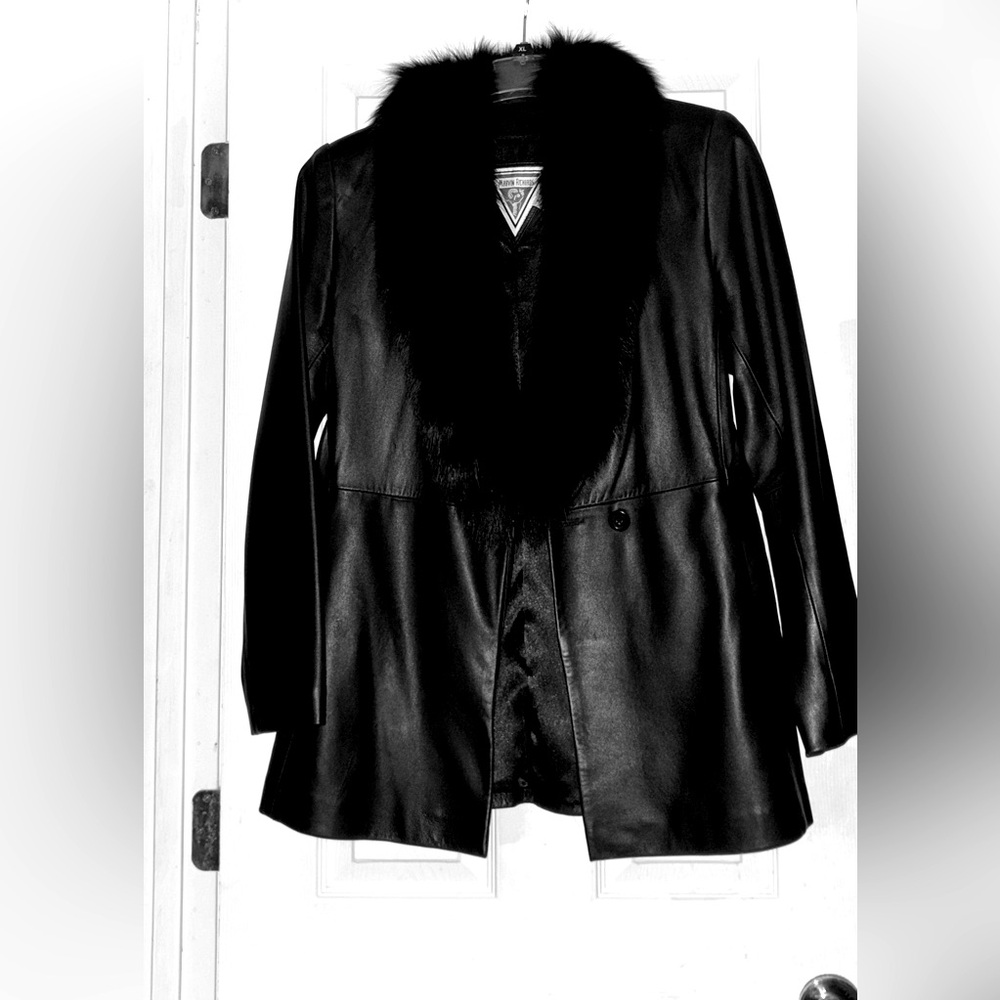 Women’s black leather coat with fur around the neck